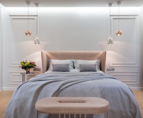 Bedroom interior with bed near table under lamps